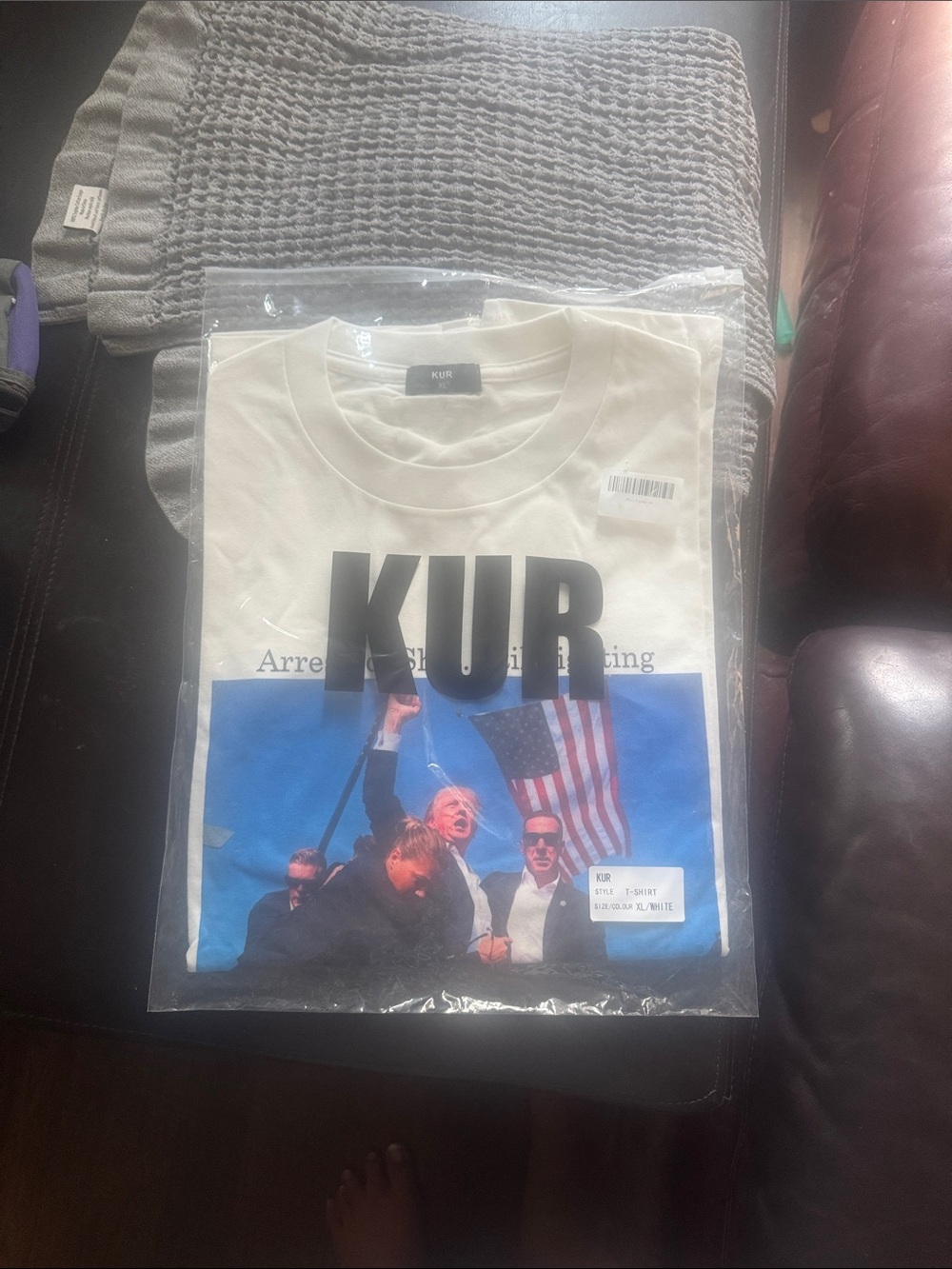 White Short-Sleeve Graphic Tee XL says Arrested.Shot.Still fighting